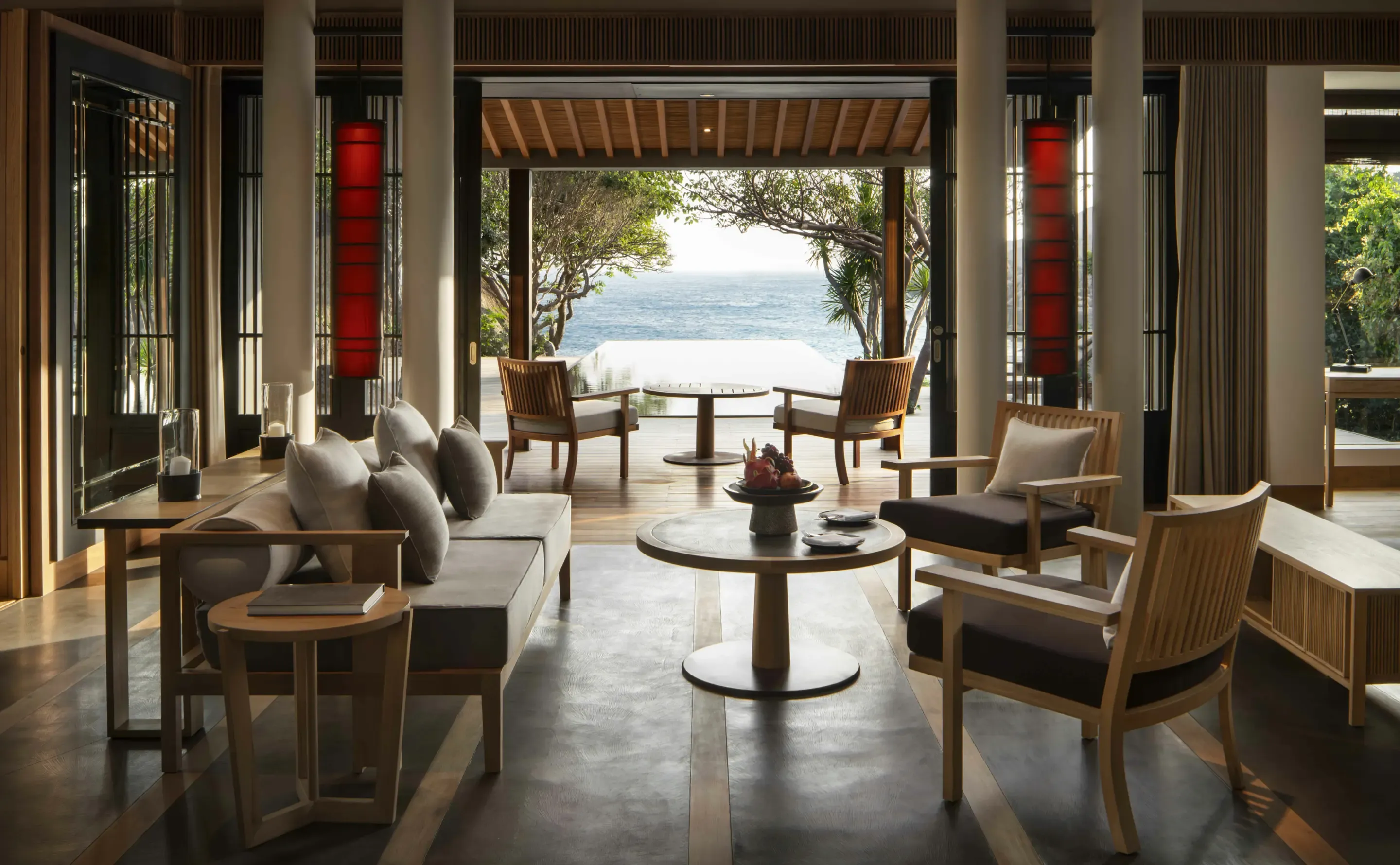 Open-air lounge looking out over an infinity pool to the sea
