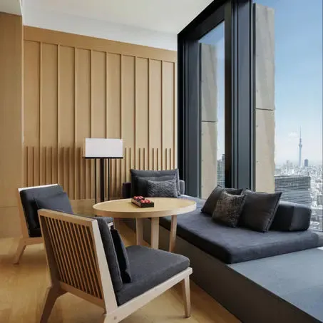 Hotel lounge with armchairs by a floor-to-ceiling window over the city